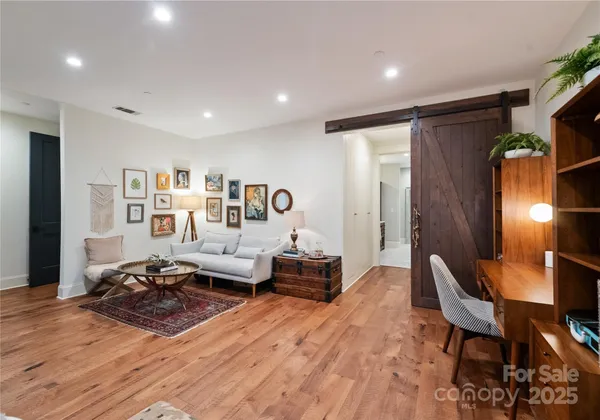 a living room with furniture a mirror and a window