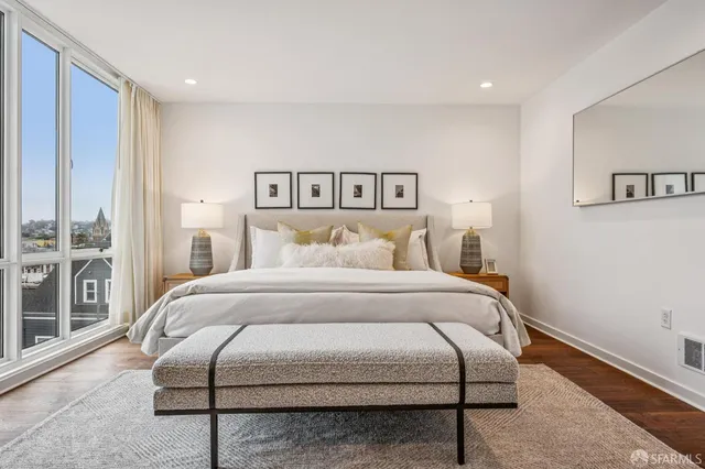 a bedroom with a large bed and a couch