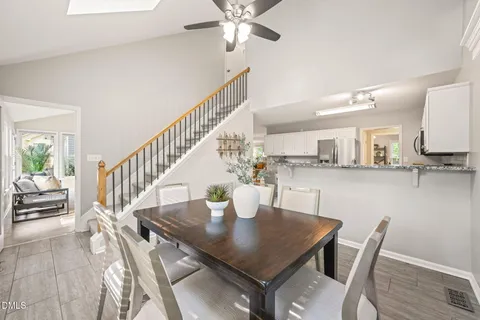 a view of a dining room with furniture large windows and wooden floor