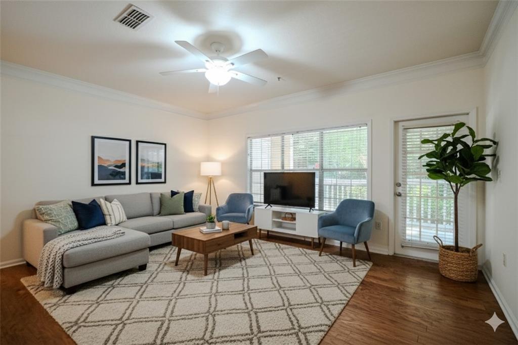 a living room with furniture a chandelier and a flat screen tv