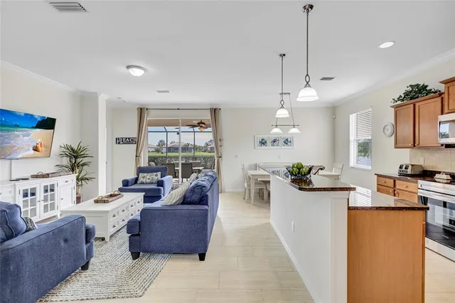 a kitchen with stainless steel appliances granite countertop a sink a stove and a refrigerator