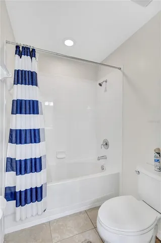 an aerial view of a city with lots of residential buildings ocean and mountain view in back