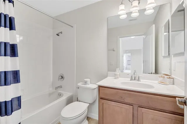 a view of a patio with a table and chairs and potted plants