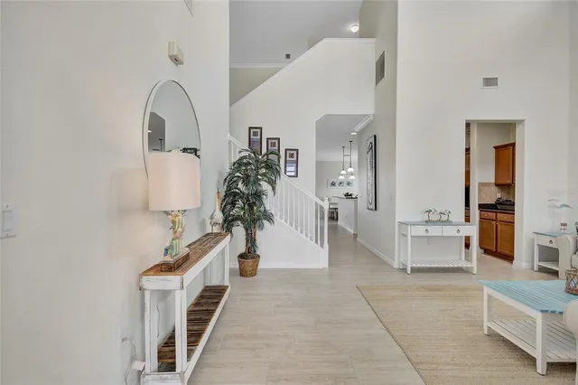 a kitchen with stainless steel appliances granite countertop a sink a stove top oven a refrigerator with island and chairs