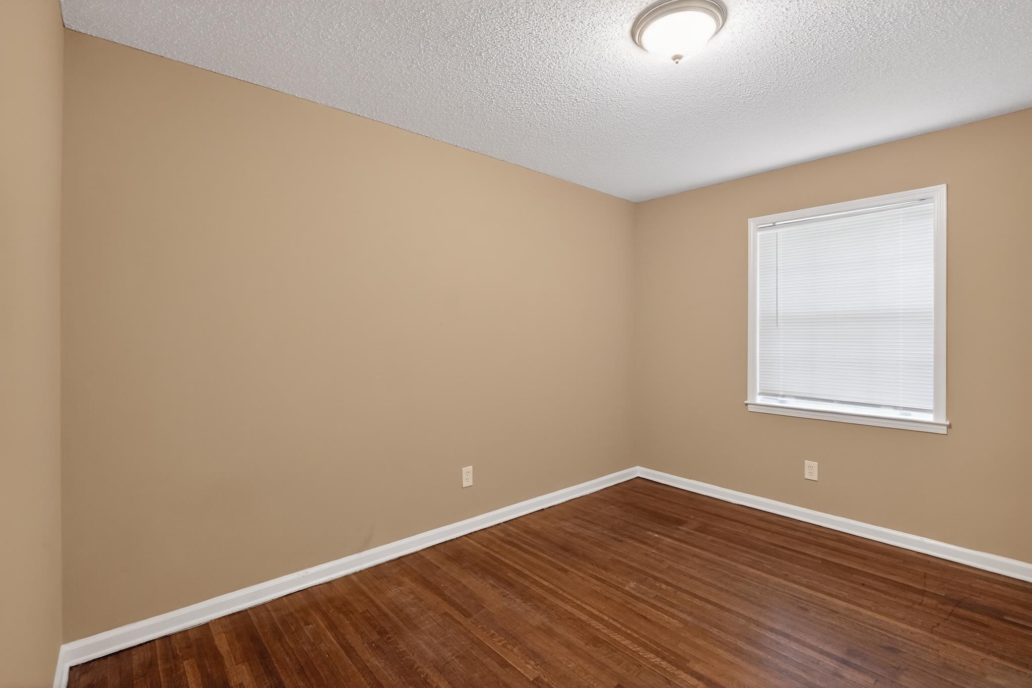 2015 East Holmes Road Memphis, TN 38116 - Photo 17 of 34 an empty room with wooden floor and windows