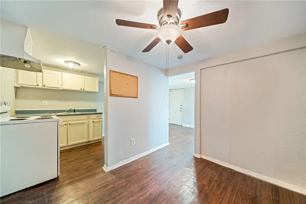 a view of a kitchen with a stove wooden floor and a refrigerator