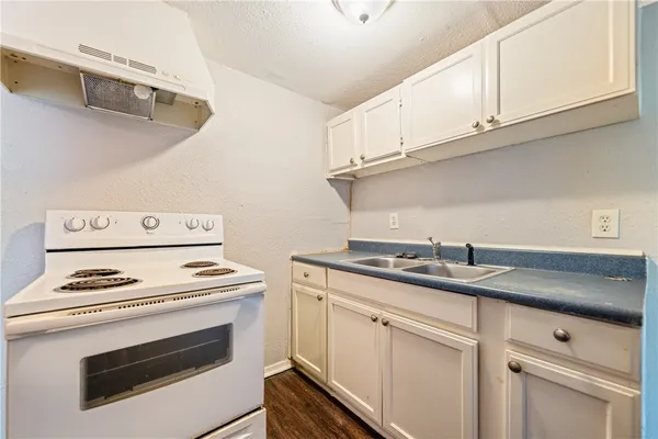 a kitchen with cabinets and appliances