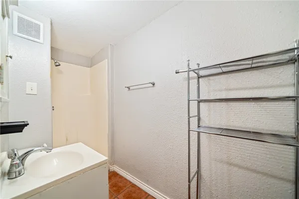 a bathroom with a sink and shower
