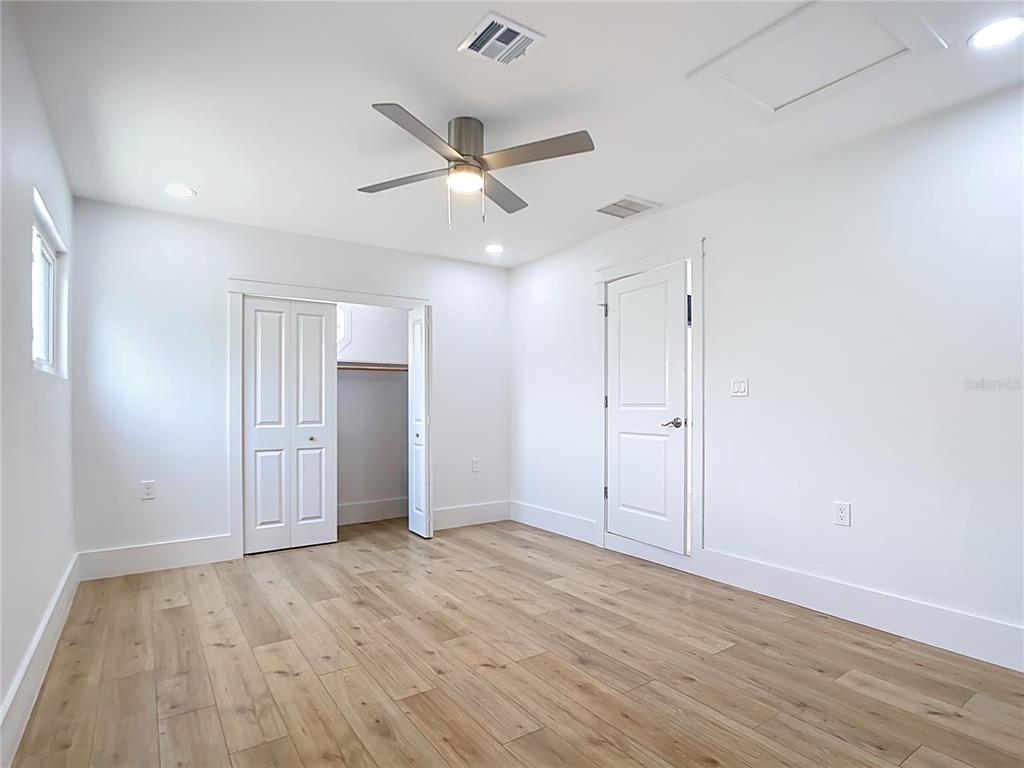 7341 Hart Street Englewood, FL 34224 - Photo 16 of 39 an empty room with wooden floor and windows