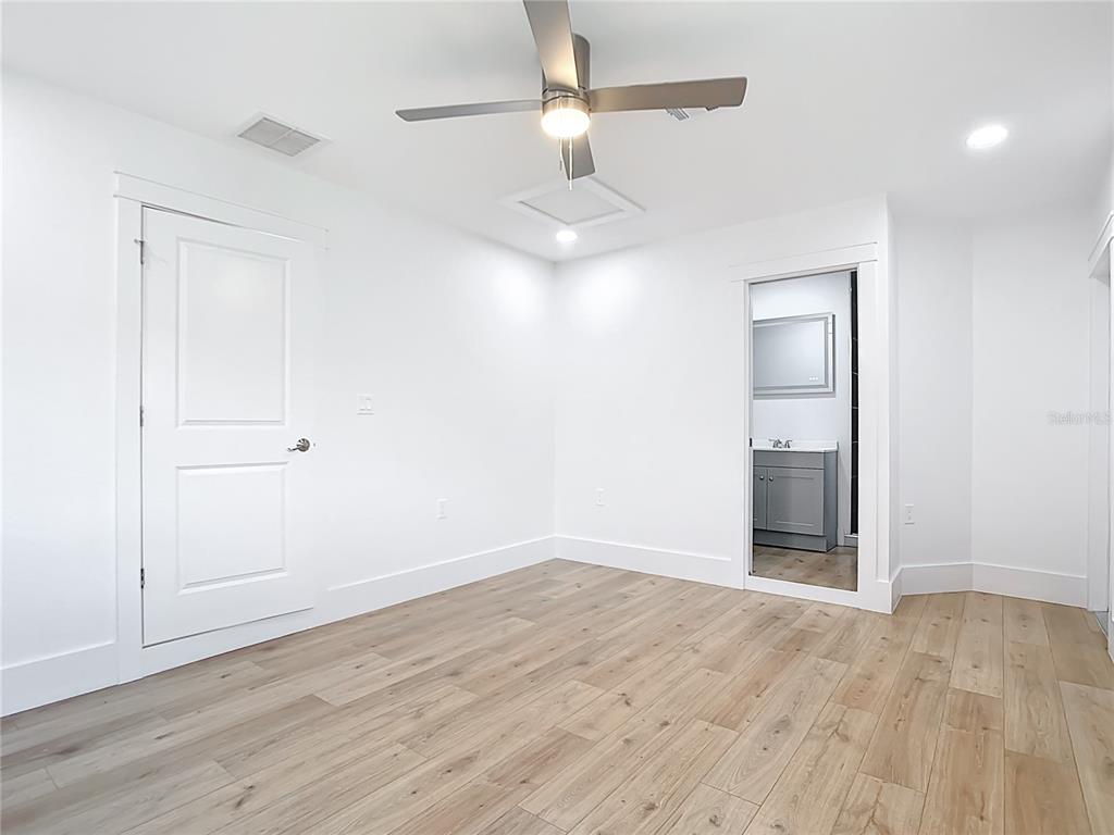 7341 Hart Street Englewood, FL 34224 - Photo 17 of 39 an empty room with wooden floor closet and windows