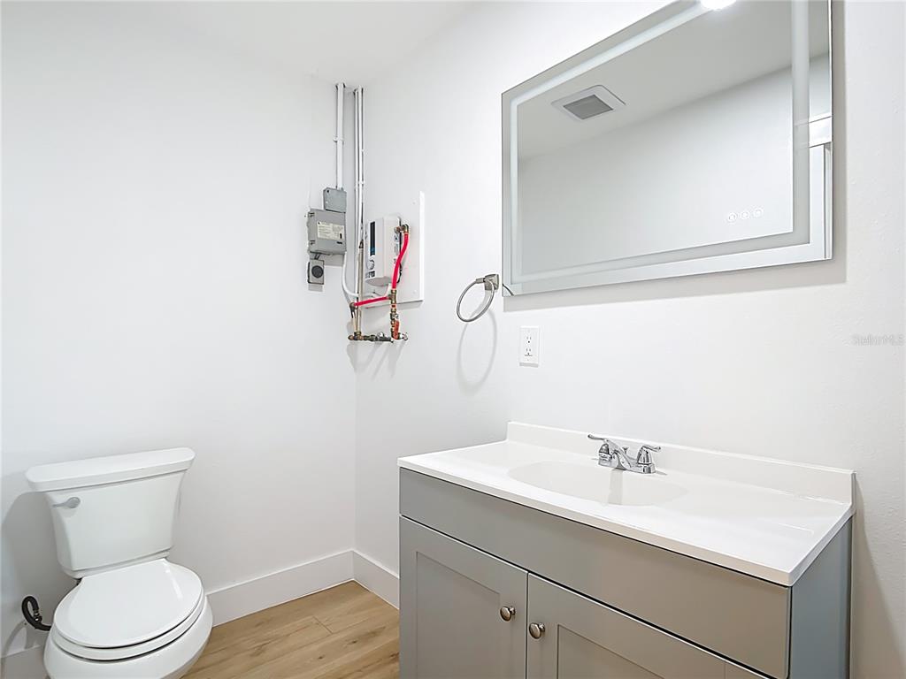 7341 Hart Street Englewood, FL 34224 - Photo 18 of 39 a bathroom with a toilet sink and mirror