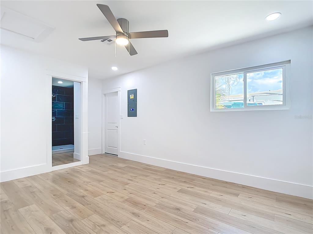 7341 Hart Street Englewood, FL 34224 - Photo 19 of 39 a view of an empty room with wooden floor and a ceiling fan
