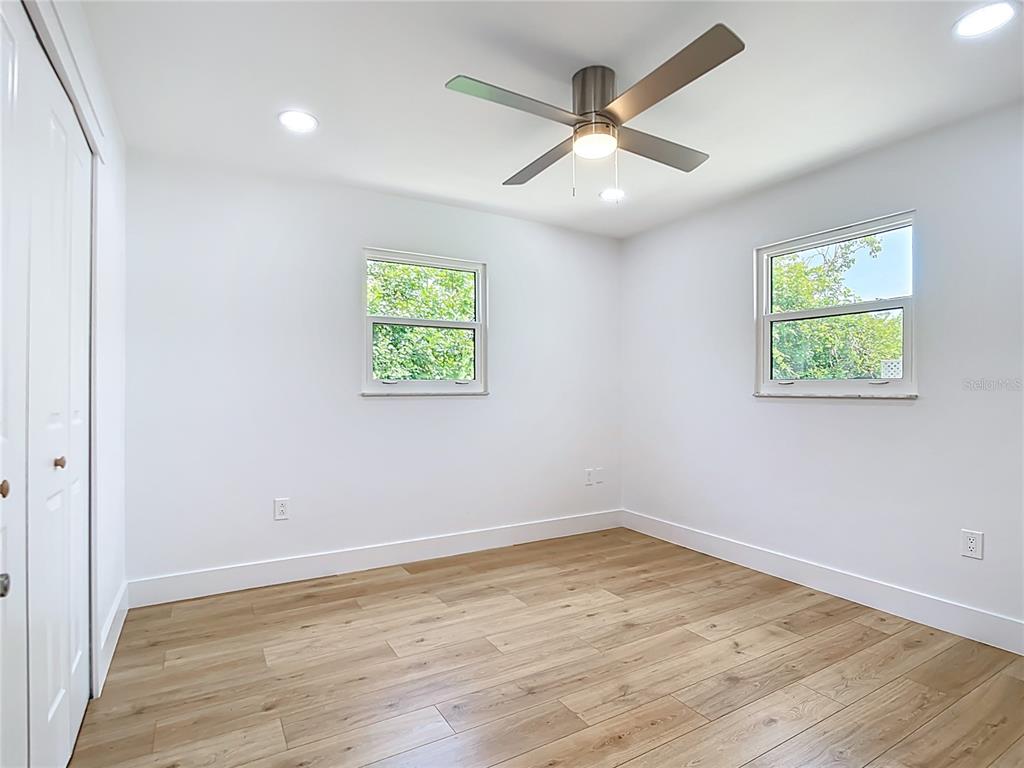 7341 Hart Street Englewood, FL 34224 - Photo 25 of 39 an empty room with wooden floor and windows
