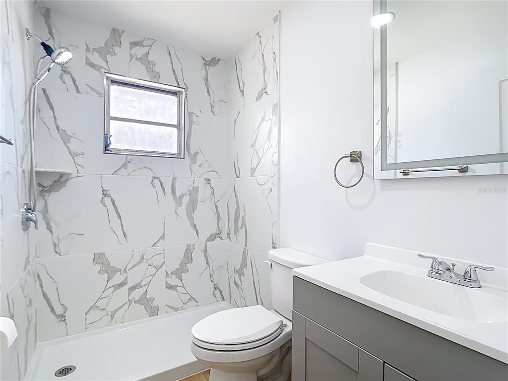 7341 Hart Street Englewood, FL 34224 - Photo 26 of 39 a bathroom with a sink a toilet and shower