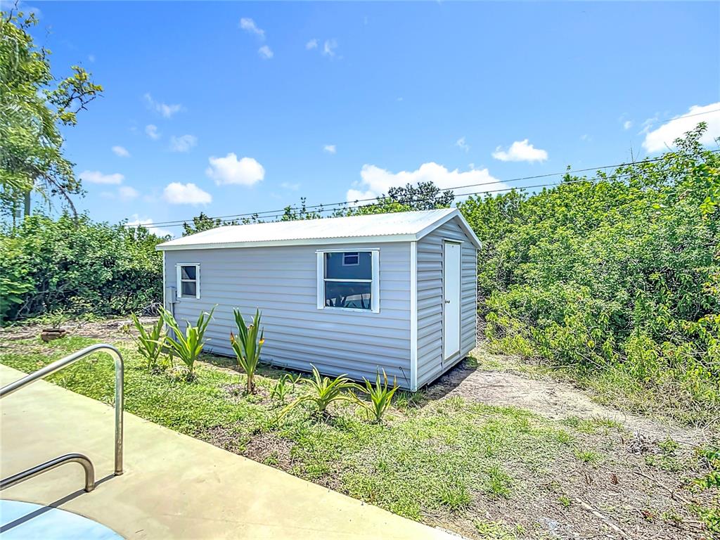 7341 Hart Street Englewood, FL 34224 - Photo 35 of 39 a backyard of a house with table and chairs