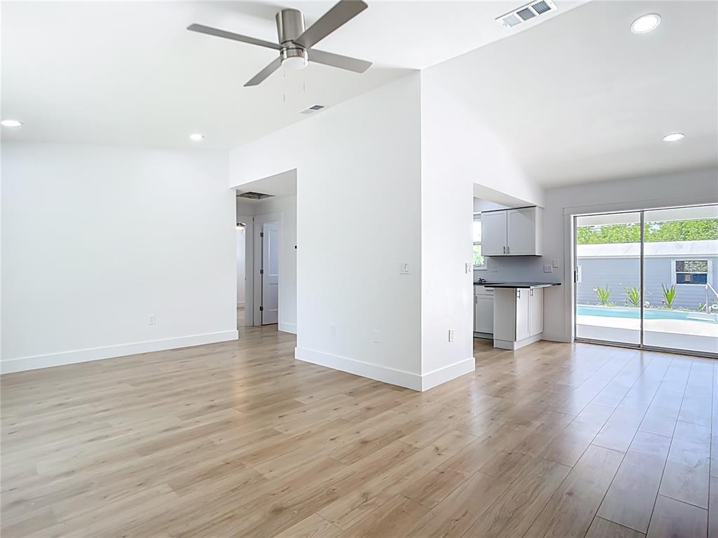 7341 Hart Street Englewood, FL 34224 - Photo 6 of 39 a view of empty room with wooden floor and fan