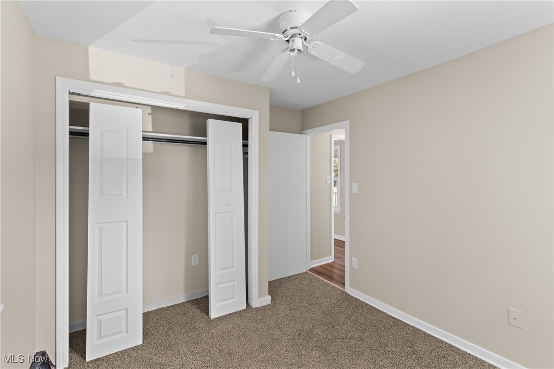 60880 Webb Heights Road Shadyside, OH 43947 - Photo 14 of 31 Unfurnished bedroom with carpet floors, a closet, and a ceiling fan