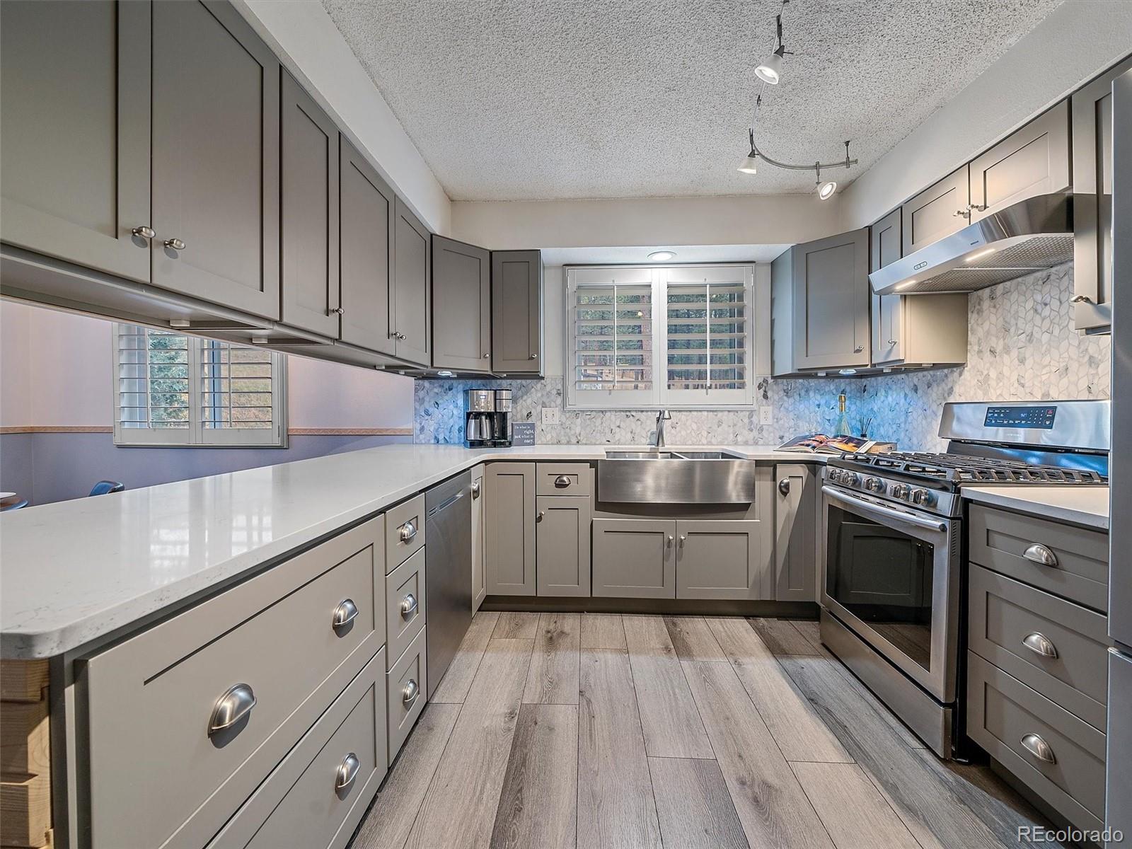 27422 Pine Valley Drive Evergreen, CO 80439 - Photo 11 of 42 a kitchen with granite countertop a sink cabinets stainless steel appliances and a window