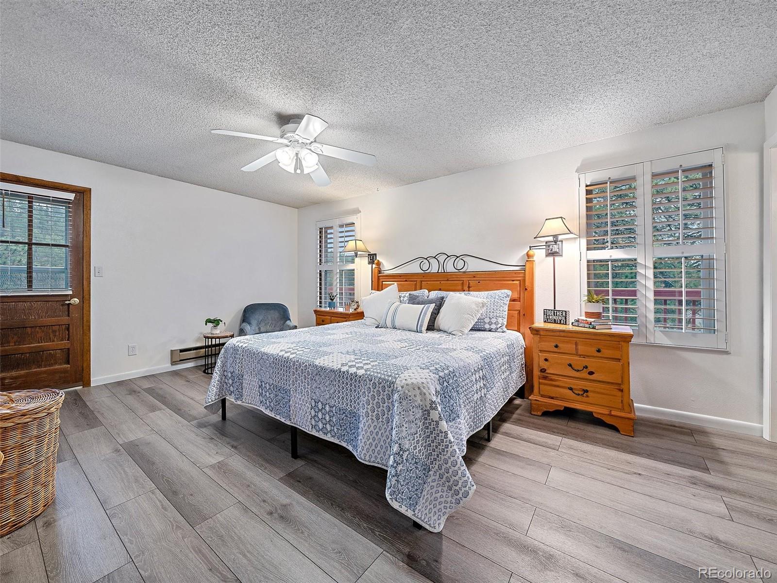 27422 Pine Valley Drive Evergreen, CO 80439 - Photo 12 of 42 a bedroom with a bed and wooden floor