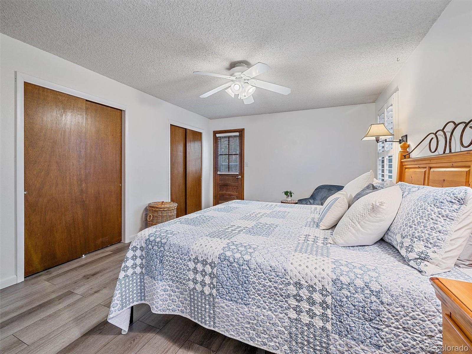 27422 Pine Valley Drive Evergreen, CO 80439 - Photo 15 of 42 a bedroom with a bed and a chandelier