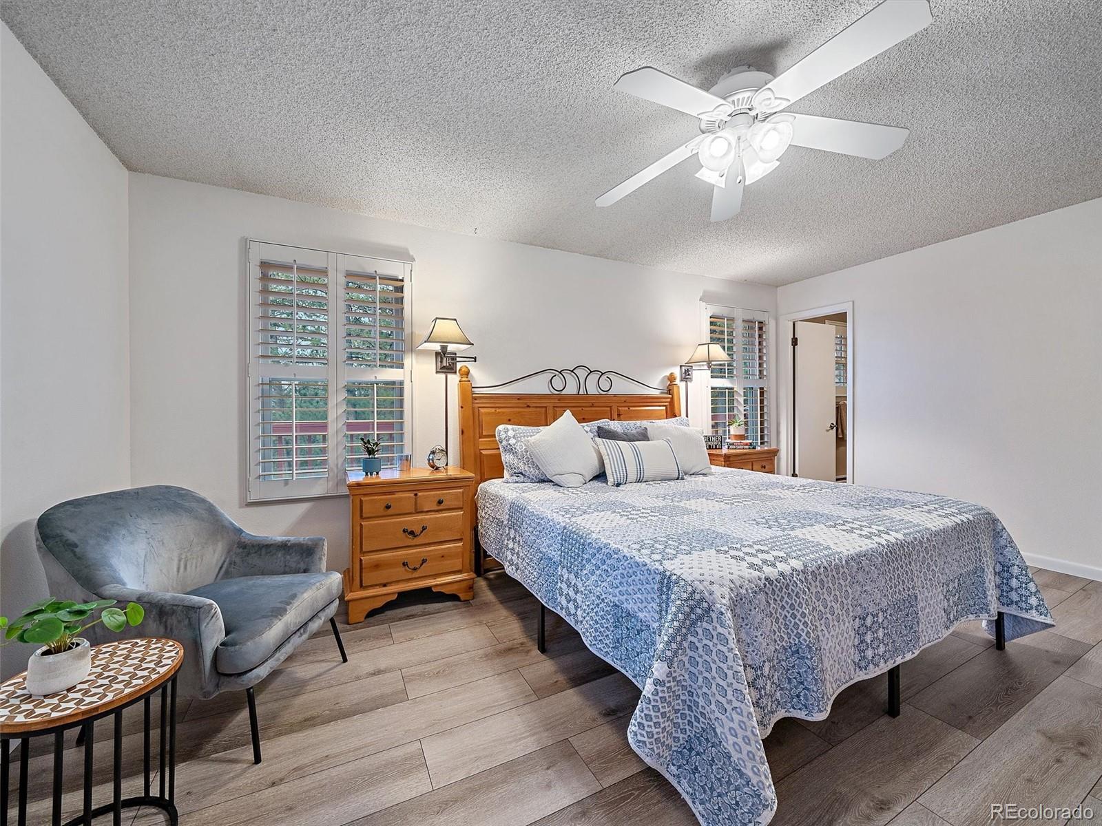 27422 Pine Valley Drive Evergreen, CO 80439 - Photo 16 of 42 a bedroom with a bed and a chair