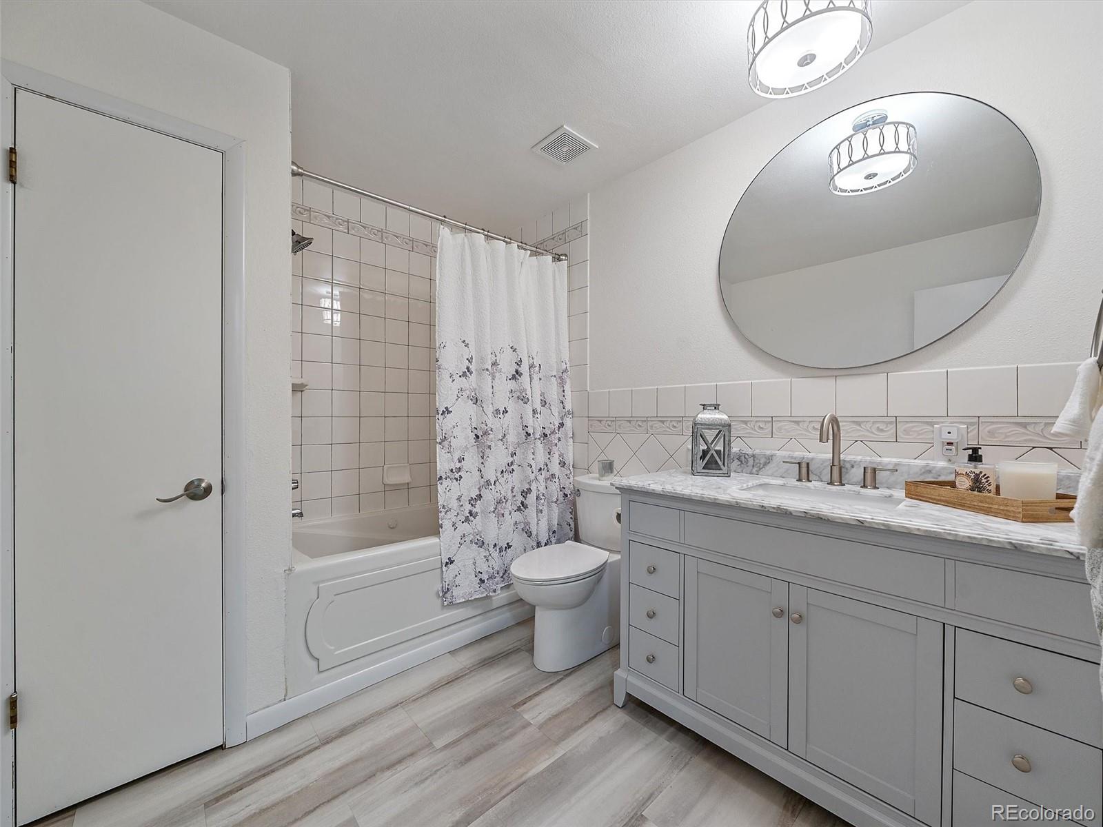 27422 Pine Valley Drive Evergreen, CO 80439 - Photo 21 of 42 a bathroom with a double vanity sink toilet and shower