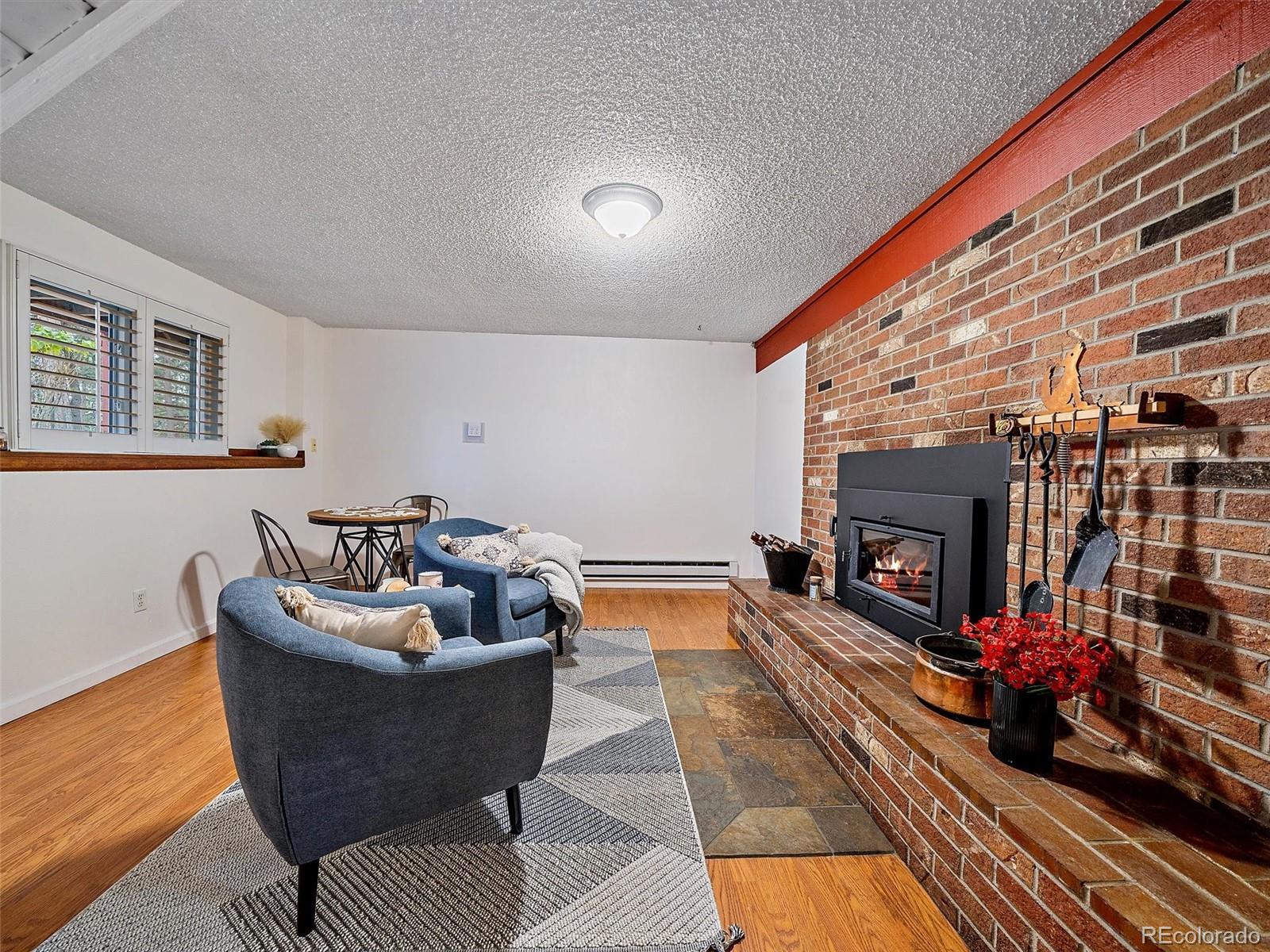 27422 Pine Valley Drive Evergreen, CO 80439 - Photo 22 of 42 a living room with furniture and a fireplace
