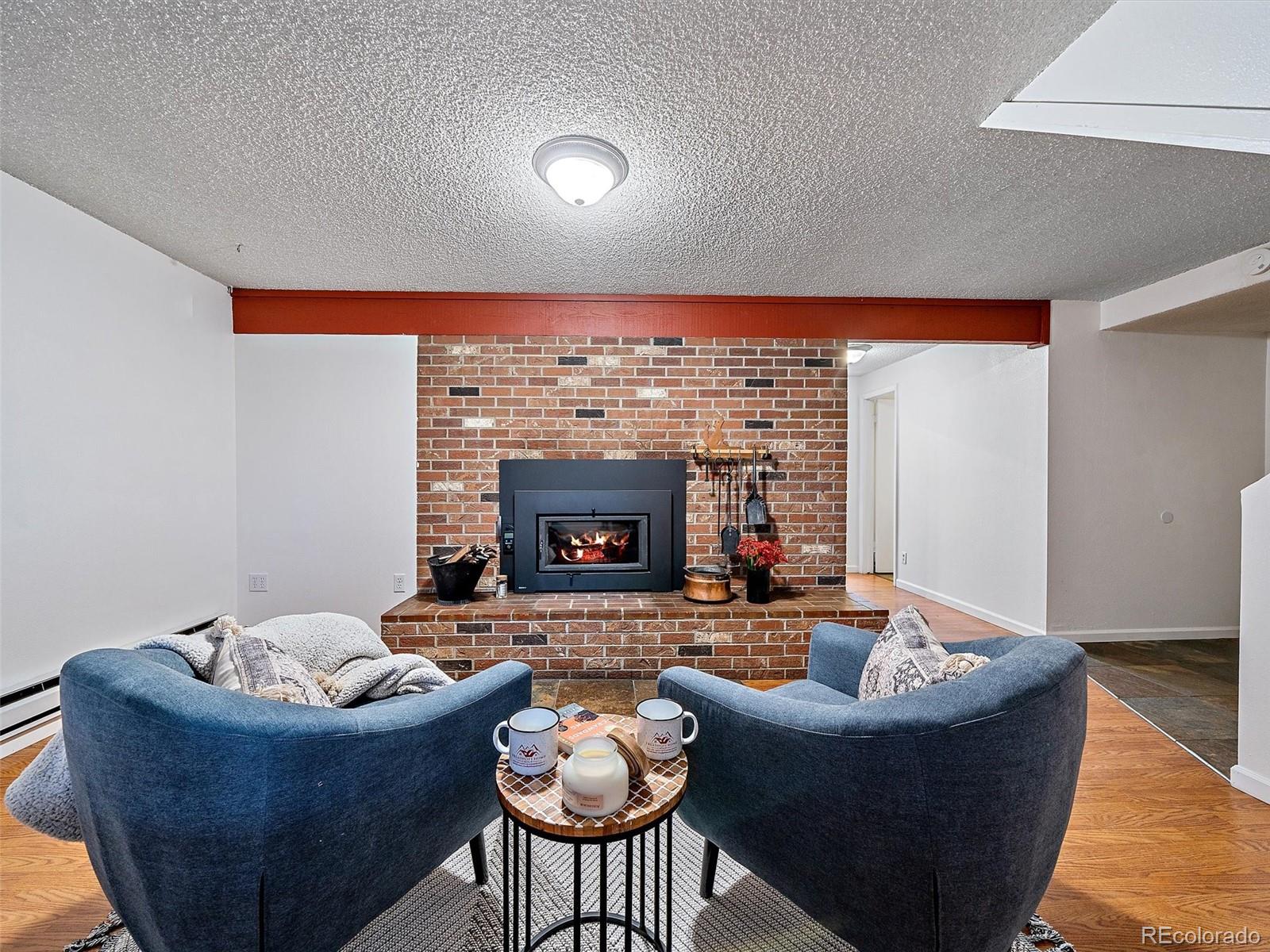27422 Pine Valley Drive Evergreen, CO 80439 - Photo 25 of 42 a living room with furniture and a fireplace