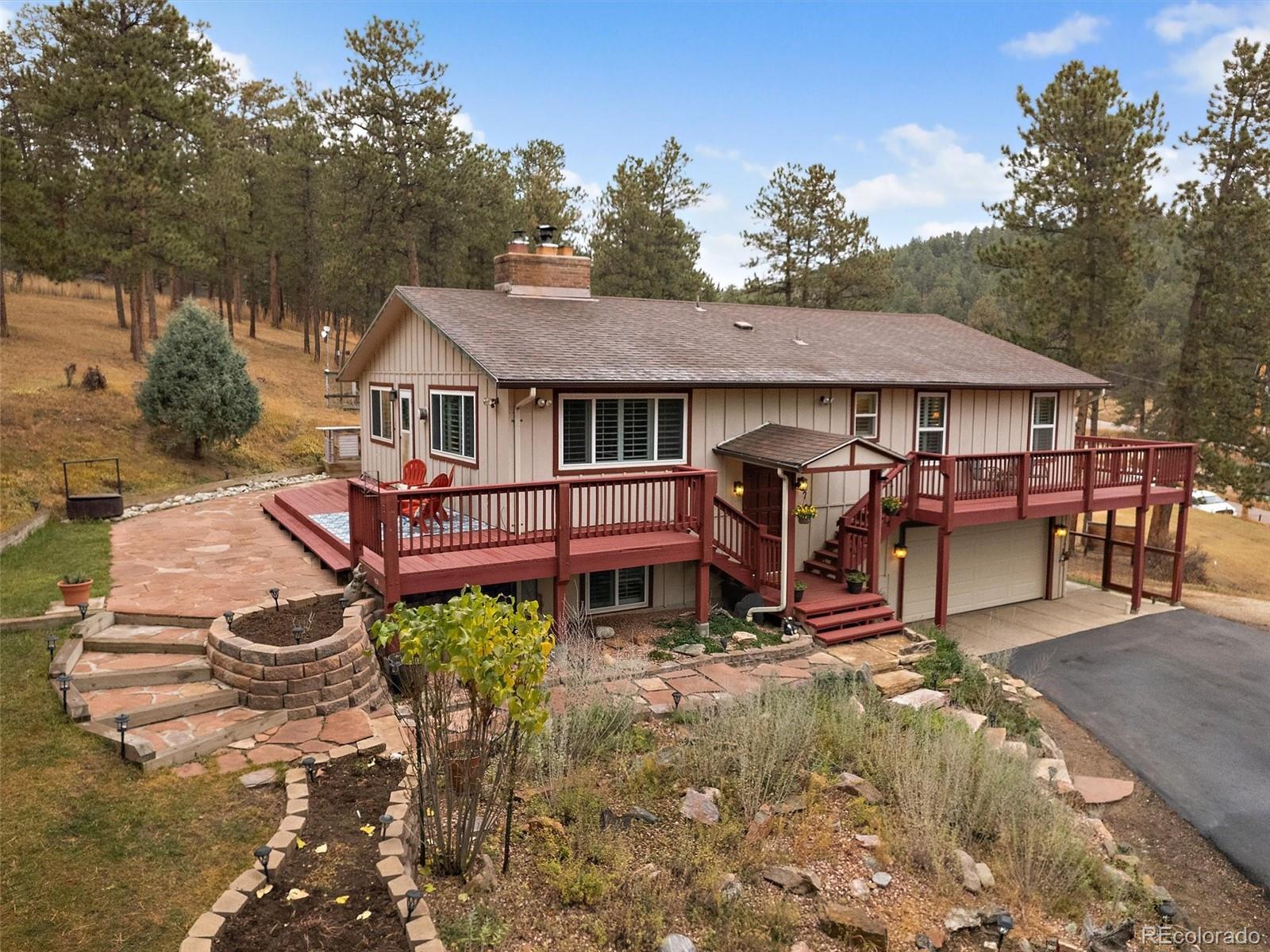27422 Pine Valley Drive Evergreen, CO 80439 - Photo 30 of 42 a view of a house with backyard and sitting area