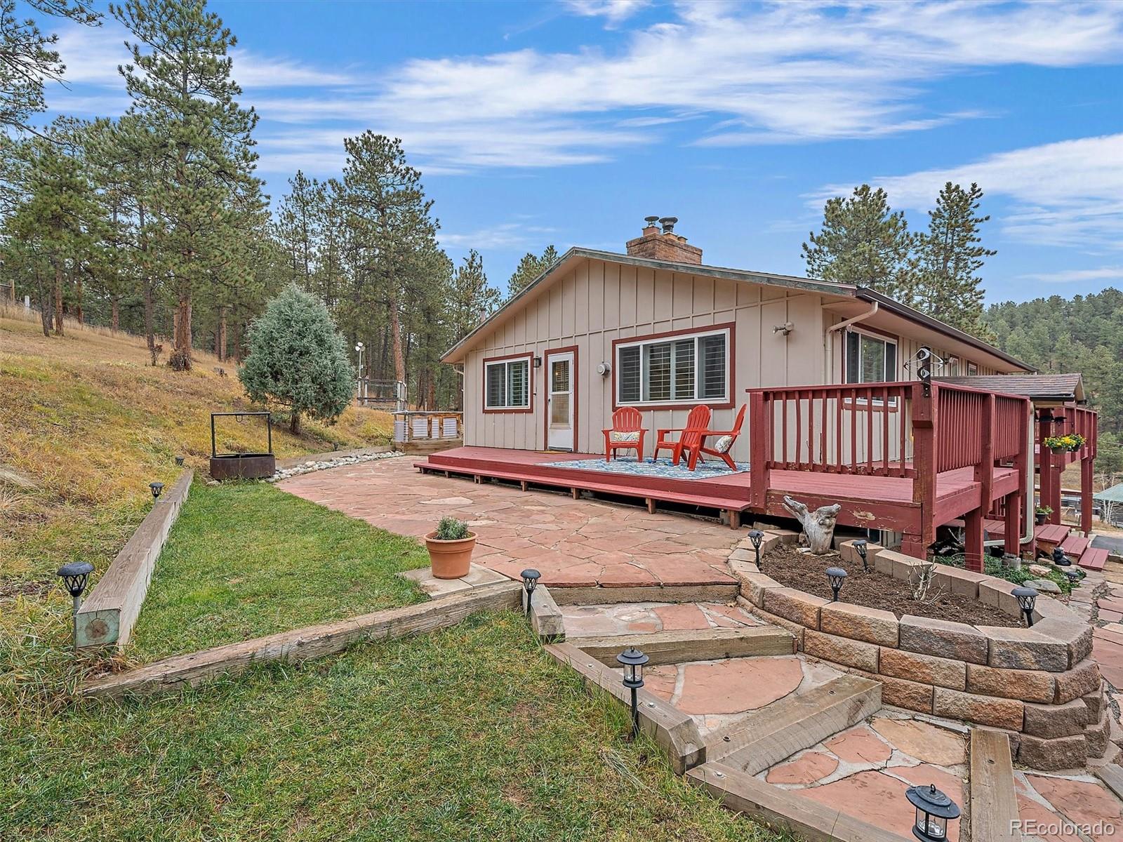 27422 Pine Valley Drive Evergreen, CO 80439 - Photo 31 of 42 a front view of a house with garden