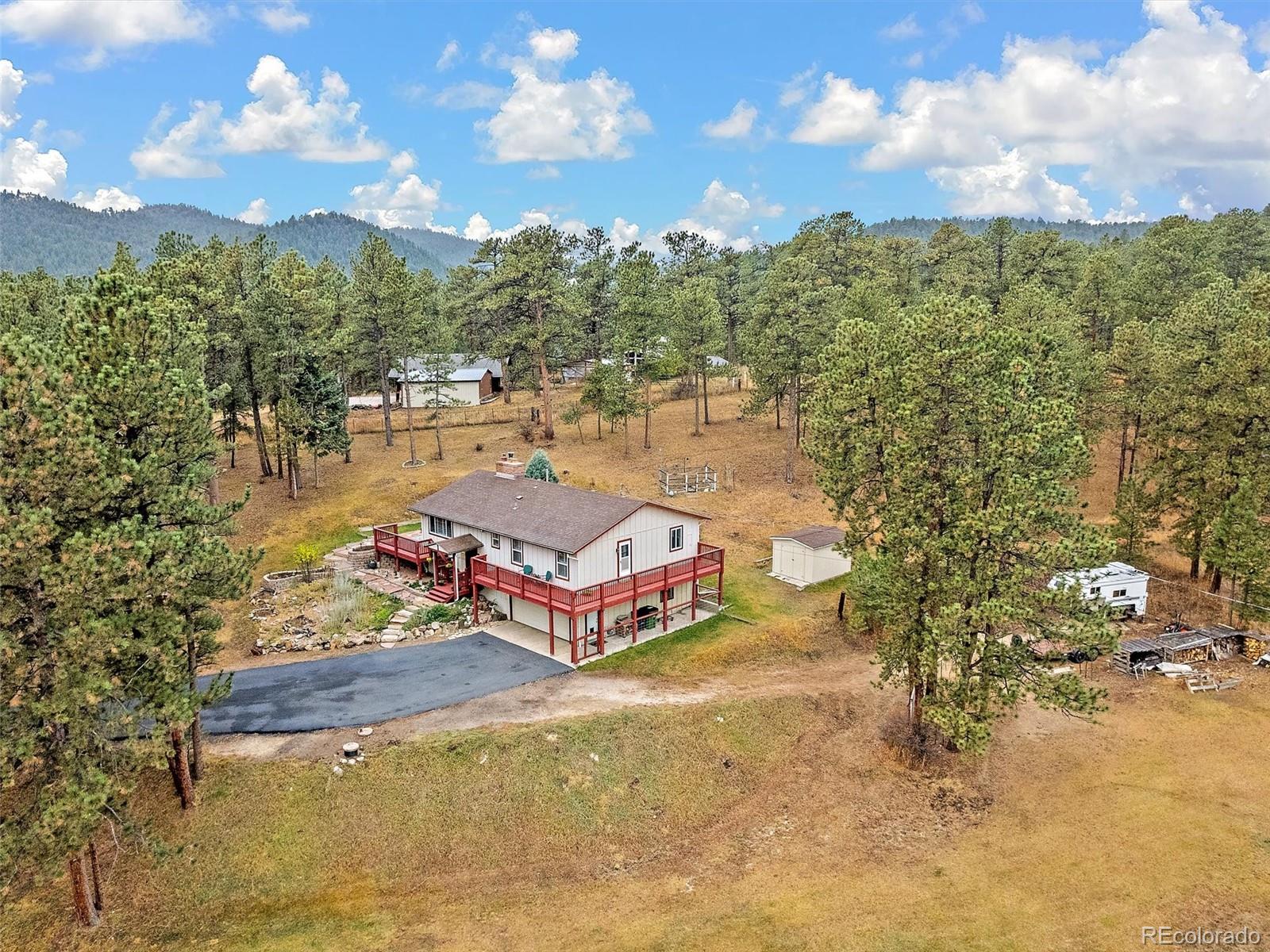 27422 Pine Valley Drive Evergreen, CO 80439 - Photo 35 of 42 a aerial view of a house with swimming pool and mountain view