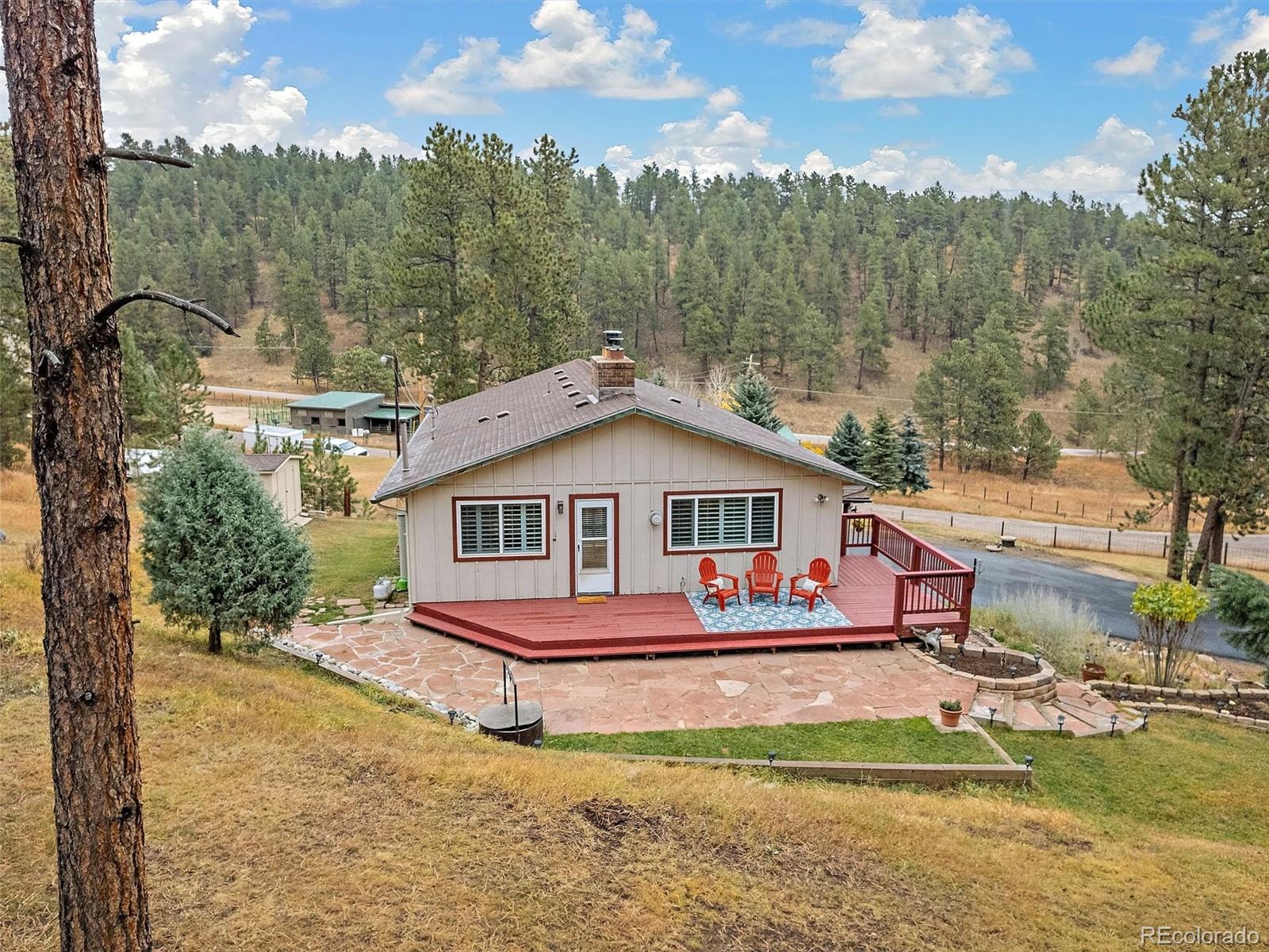 27422 Pine Valley Drive Evergreen, CO 80439 - Photo 39 of 42 a view of a white house with a big yard and large trees