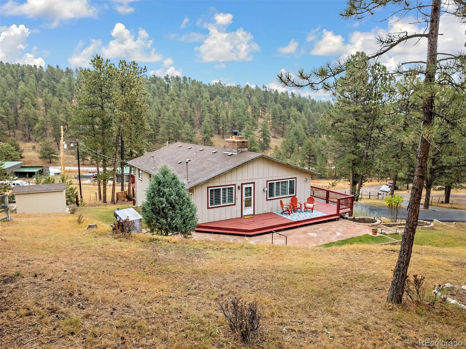 27422 Pine Valley Drive Evergreen, CO 80439 - Photo 40 of 42 a view of a house with a yard