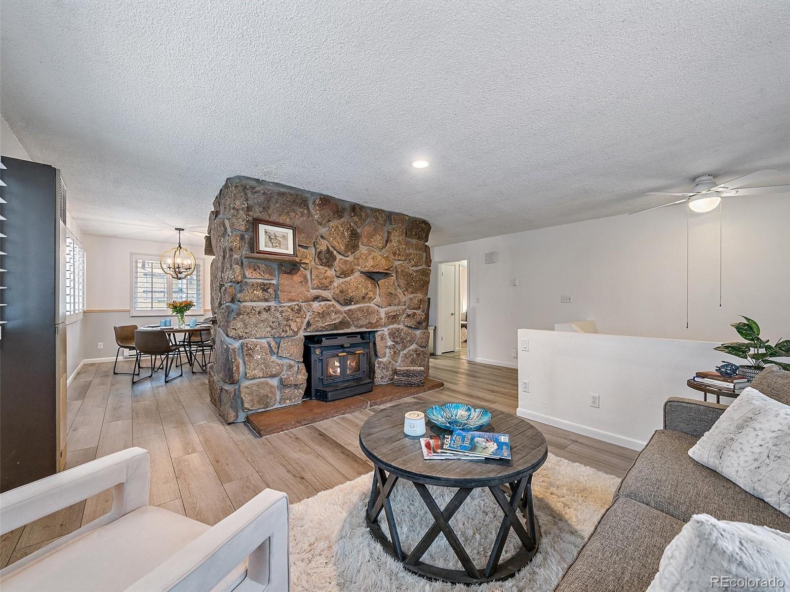 27422 Pine Valley Drive Evergreen, CO 80439 - Photo 5 of 42 a living room with furniture and a fireplace