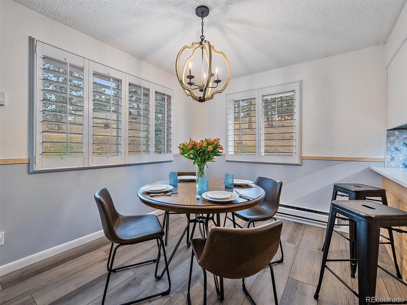 27422 Pine Valley Drive Evergreen, CO 80439 - Photo 8 of 42 a view of a dining room with furniture window and outside view