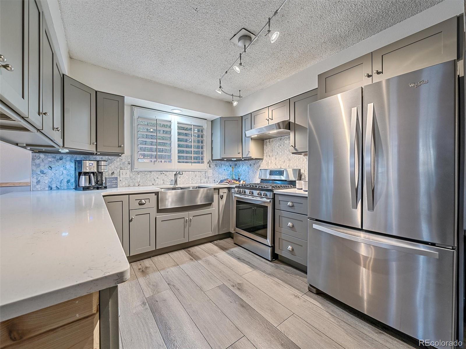 27422 Pine Valley Drive Evergreen, CO 80439 - Photo 10 of 42 a kitchen with granite countertop stainless steel appliances a refrigerator sink and microwave