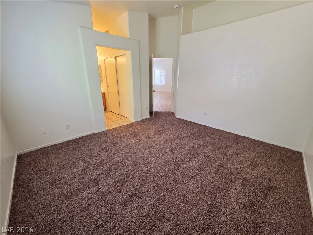 9609 Crystal Ridge Road Las Vegas, NV 89123 - Photo 17 of 21 Plush wall-to-wall carpeting and soaring high ceilings define this versatile bedroom space.