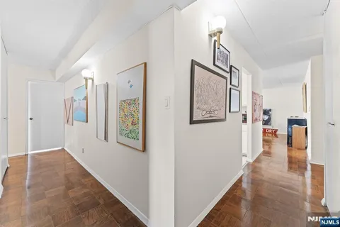 a view of a hallway with wooden floor