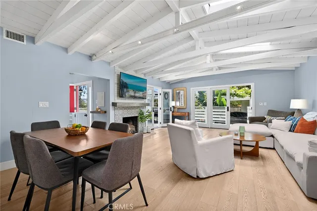 a living room with fireplace furniture and a wooden floor