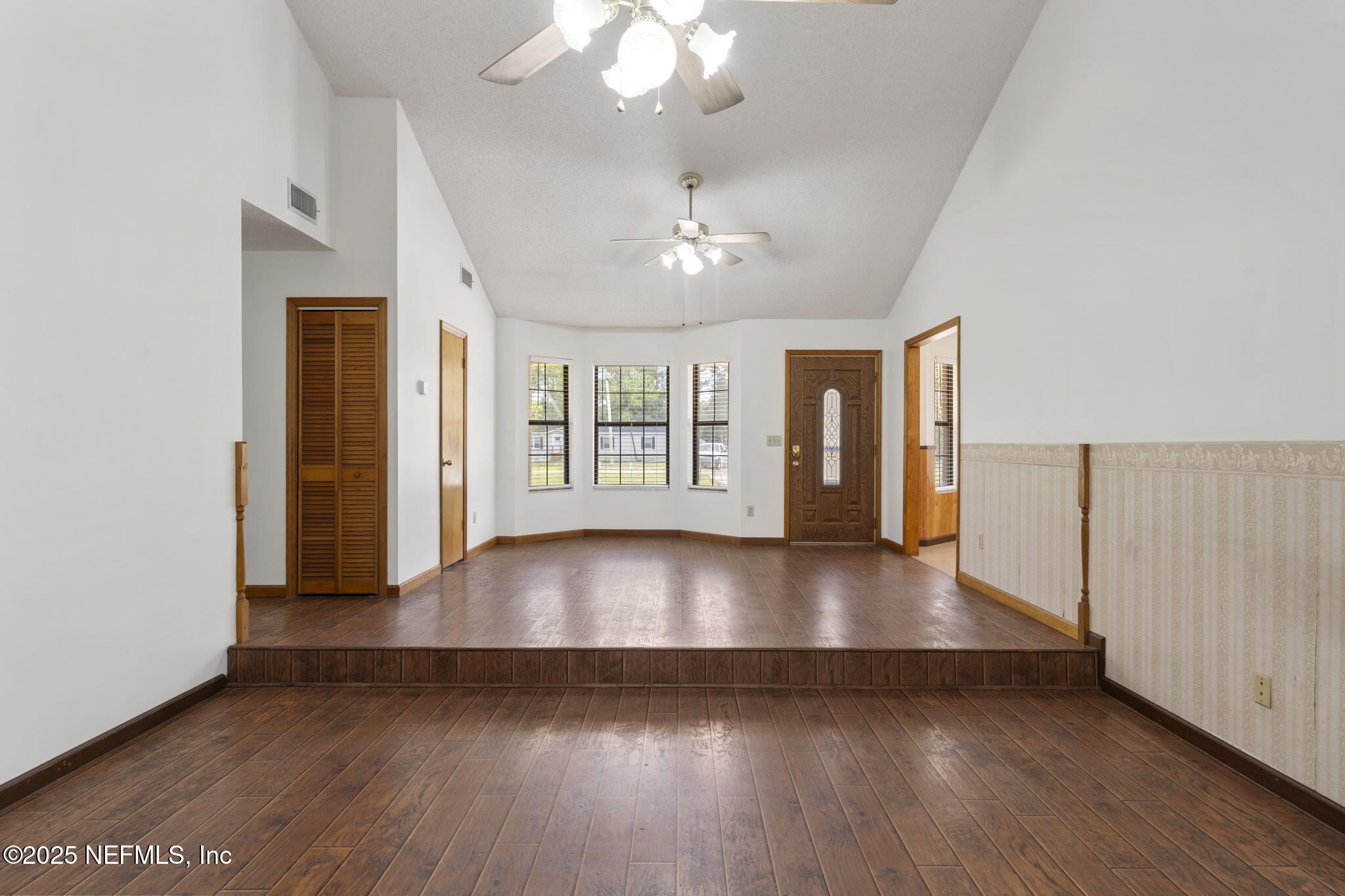 54230 Heller Road Callahan, FL 32011 - Photo 12 of 37 a view of an empty room with wooden floor and a window