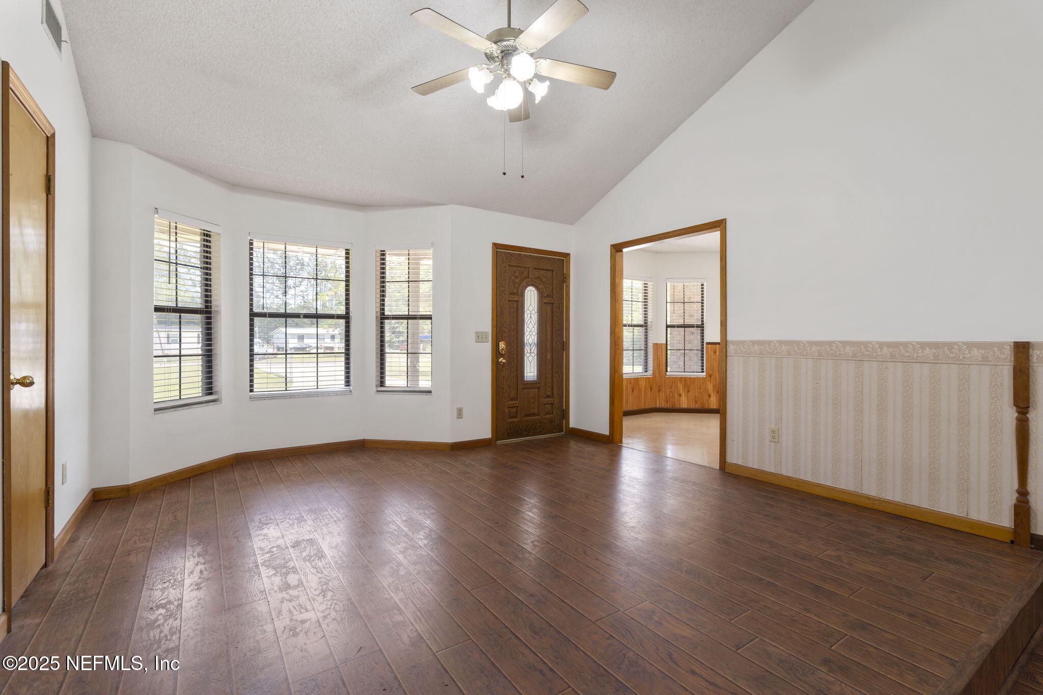 54230 Heller Road Callahan, FL 32011 - Photo 13 of 37 a view of an empty room with wooden floor and a window