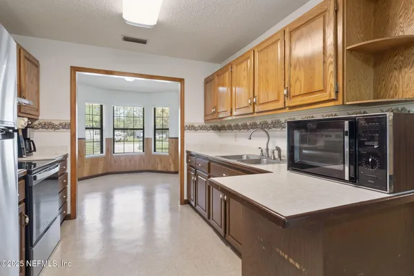 a kitchen with stainless steel appliances a stove and a refrigerator