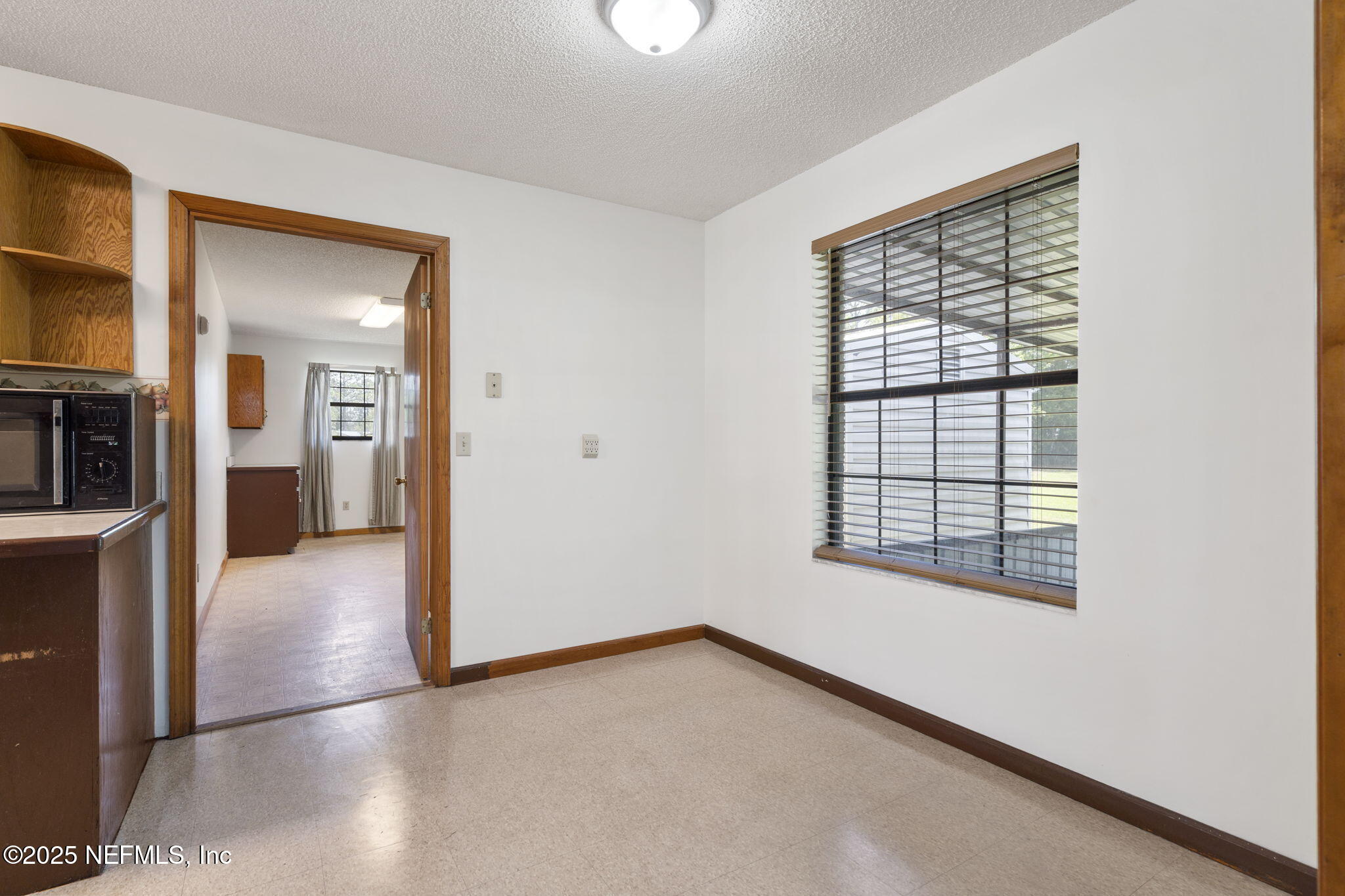 54230 Heller Road Callahan, FL 32011 - Photo 19 of 37 an empty room with windows and entrance