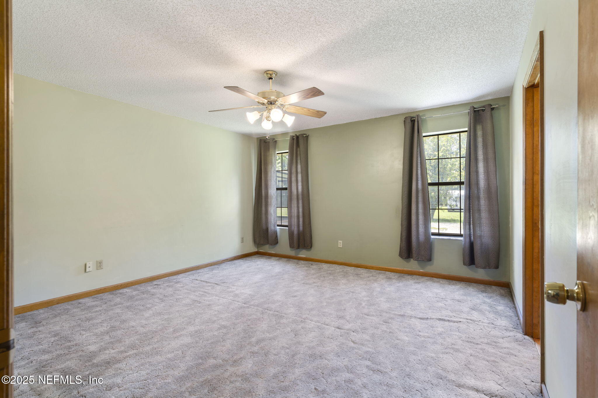 54230 Heller Road Callahan, FL 32011 - Photo 23 of 37 an empty room with windows and fan