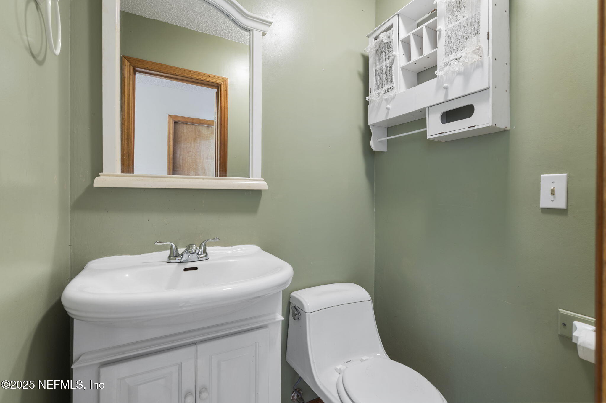 54230 Heller Road Callahan, FL 32011 - Photo 28 of 37 a bathroom with a sink mirror and toilet