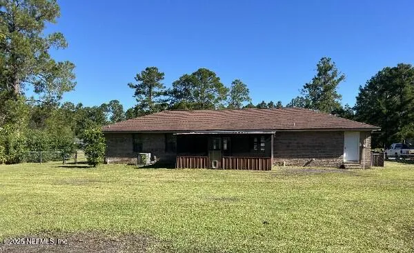 a backyard of a house with yard and outdoor seating