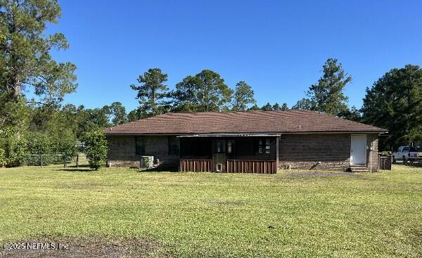 54230 Heller Road Callahan, FL 32011 - Photo 30 of 37 a backyard of a house with yard and outdoor seating