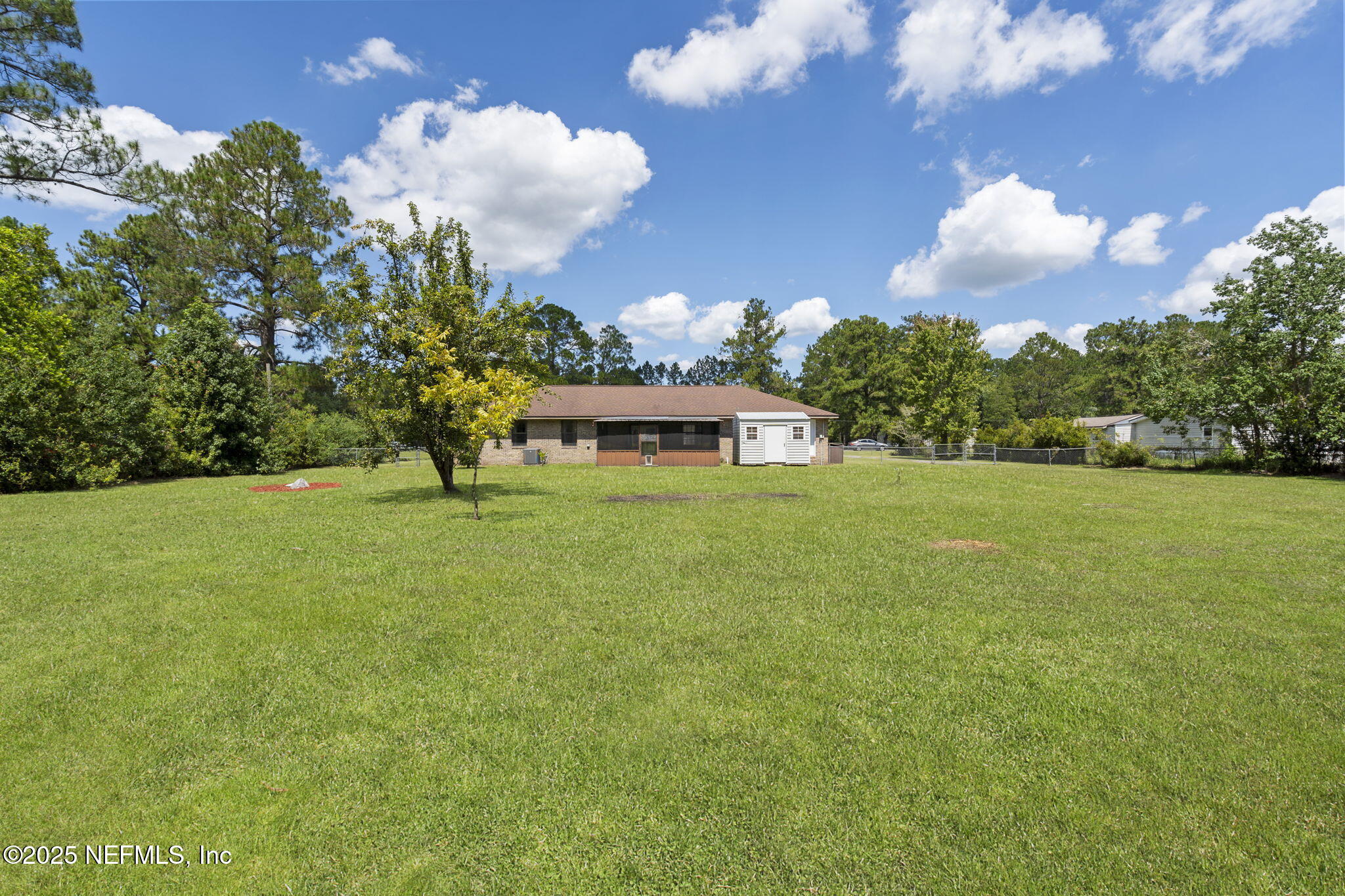 54230 Heller Road Callahan, FL 32011 - Photo 34 of 37 a view of a fountain in front of a house with a big yard