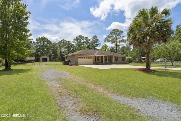 a front view of house with yard and green space