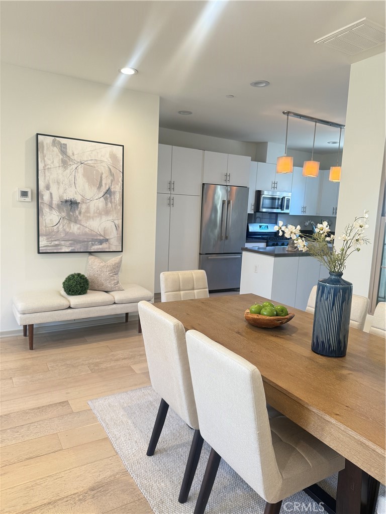 87 Evening Sun Irvine, CA 92620 - Photo 11 of 29 a kitchen with a table chairs and refrigerator